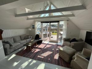 a living room with a couch and a table at Cozy Holiday Home With Character in Nakskov