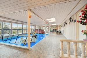 a swimming pool in the middle of a house at Pool House With Space For Relaxation in Bording Stationsby