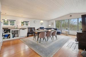 a kitchen and living room with a table and chairs at Pool House With Space For Relaxation in Bording Stationsby