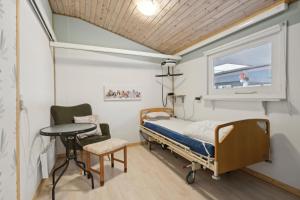 a hospital room with a bed and a table and a window at Pool House With Space For Relaxation in Bording Stationsby +23 photos