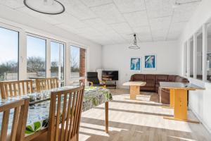a living room with a couch and a table at House For 40 People Near Thy in Gettrup