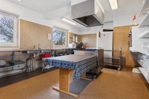 a kitchen with a table in the middle of it at House For 40 People Near Thy in Gettrup