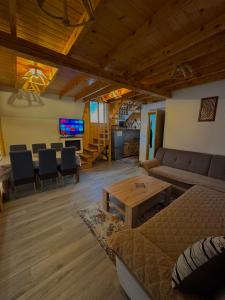 a living room with a couch and a table at Vlasic Odmor - Villa Krajina IV & jacuzzi in Vlasic