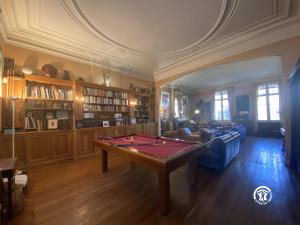 a room with a ping pong table in a room at La maison bachelet in Claira