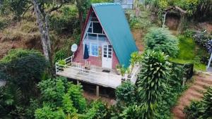 an aerial view of a small house with a blue roof at Dehigasella Cabana in Bandarawela