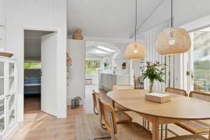 a dining room and kitchen with a table and chairs at Scenic Holiday Home In Bratten in Jerup