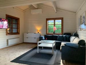 a living room with a couch and a table at Experience The Forest And Sea in Ålsgårde