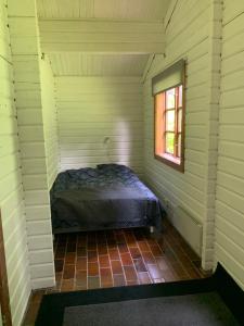 a bedroom with a bed in a room with a window at Experience The Forest And Sea in Ålsgårde