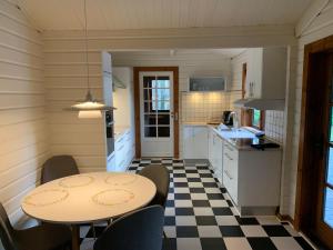 a kitchen with a table and chairs in a room at Experience The Forest And Sea in Ålsgårde
