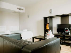 a living room with a couch and a television at Ibis Sofia Airport Hotel in Sofia