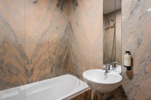 a bathroom with a sink and a toilet and a tub at Coreto Bento Freitas in Vila do Conde