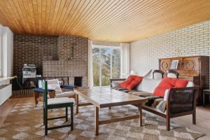 a living room with a couch and a table at Cozy Holiday Home In Thisted in Thisted +16 photos