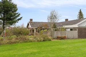 a house with a fence in a yard at Cozy Holiday Home In Thisted in Thisted