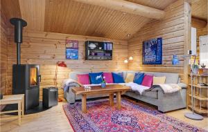 a living room with a couch and a table at Cozy Log Cabin With A Panoramic View in Glesborg