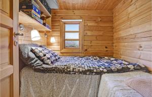 a bedroom with a bed in a log cabin at Cozy Log Cabin With A Panoramic View in Glesborg