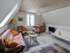 a living room with a couch and a table at Lovely 2-Story Cabin By The Sea On Bornholm in Svaneke