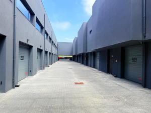 an empty hallway of a building with garage doors at Motel Unique Private Suites in Leça da Palmeira
