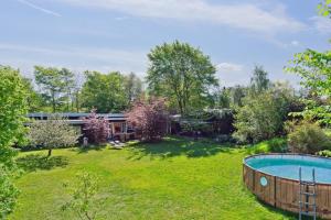 a yard with a pool and a house at Spacious Summer House With Pool in Vejby +18 photos