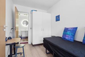 a bedroom with a bed and a desk and a chair at Cozy Apartment In Tønder in Tønder