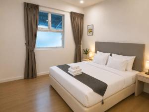a bedroom with a large bed and a window at Lawson Inn in Sibu +114 photos