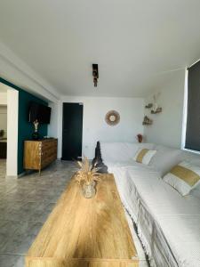 a bedroom with two beds and a wooden table at infinity sky stay in episkopi-heraklion