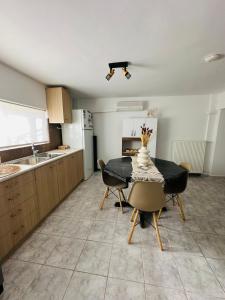 a kitchen with a table and chairs in a room at infinity sky stay in episkopi-heraklion +24 photos