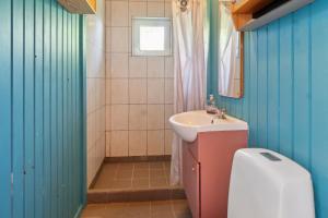 a bathroom with a sink and a toilet in it at Romantic Retreat Close To The Beach in Fårevejle +29 photos
