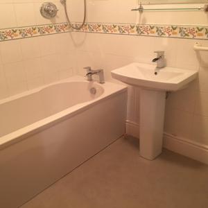 a bathroom with a bath tub and a sink at Ivy Bank Guest House - Room Only in Windermere