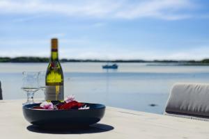 a bottle of wine and a glass on a table at Lovely Beach House With Panoramic View in Martofte