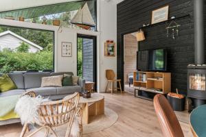 a living room with a couch and a fireplace at Scenic Summer House In Asserbo in Frederiksværk