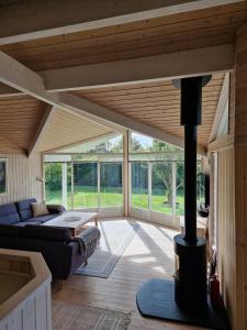a living room with a wood stove in the middle at Cozy And Well-Maintained Holiday Home in Eskebjerg