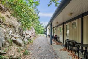 a walkway next to a building with tables and chairs at Lovely Holiday Apartment Consumption Included in Allinge