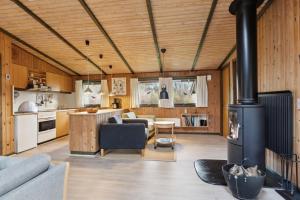 a living room with a fireplace in a house at Cozy Summer House In Trend in Løgstør