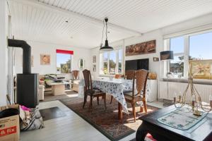 a dining room with a table and chairs at Summer House In Thyholm in Thyholm