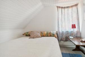 a white bed in a room with a window at Summer House In Thyholm in Thyholm