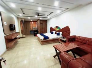 a living room with a bed and a couch at Hotel The Novelty in Kānpur