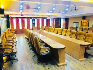 a conference room with a long table and chairs at Hotel The Novelty in Kānpur
