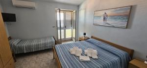 a bedroom with a bed with towels on it at Residenza Laura Casa Vacanze Capo Vaticano in Capo Vaticano +193 photos