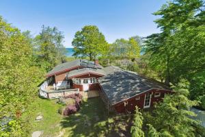 an overhead view of a red house in the woods at Togetherness Coziness Magical Great Belt View in Tranekær