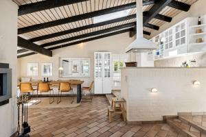 a kitchen and living room with a table and chairs at Togetherness Coziness Magical Great Belt View in Tranekær +23 photos