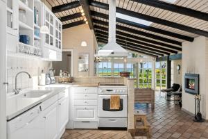a kitchen with a sink and a stove top oven at Togetherness Coziness Magical Great Belt View in Tranekær