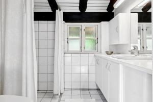 a white bathroom with a sink and a window at Togetherness Coziness Magical Great Belt View in Tranekær