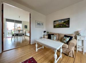 a living room with a couch and a table at Charming Holiday Apartment In Central Stege in Stege