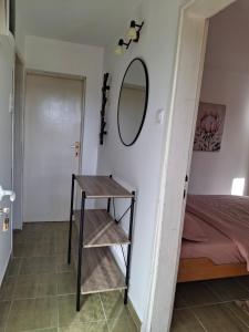 a room with a table and a mirror and a bed at Apartment Moki in Lastva