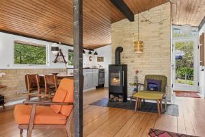 a kitchen and living room with a wood stove at Nostalgic 1960S Idyll in Kulhuse +32 photos