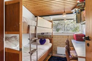 a small room with a bunk bed and a table at Nostalgic 1960S Idyll in Kulhuse