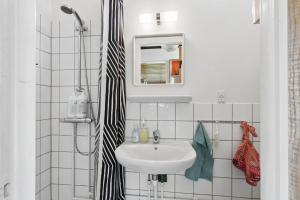 a bathroom with a sink and a mirror at Nostalgic 1960S Idyll in Kulhuse