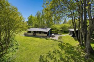 a house in the middle of a grassy yard at Nostalgic 1960S Idyll in Kulhuse