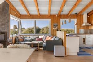a living room with a couch and a table at Simple Summer Living In Magical Setting in Nykøbing Sjælland