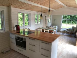 a kitchen with a counter top and a living room at Holiday Home Near Nordstrand Nykøbing Sj in Nykøbing Sjælland